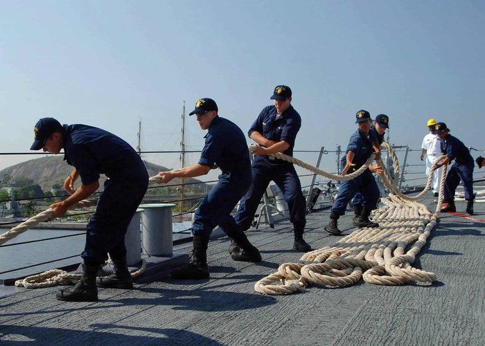 sailors pulling a rope on deck